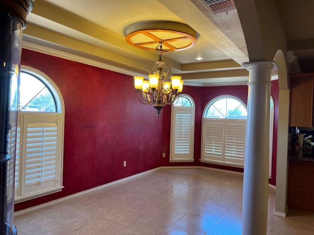 unfurnished dining area with ornate columns, a raised ceiling, a wealth of natural light, and a notable chandelier