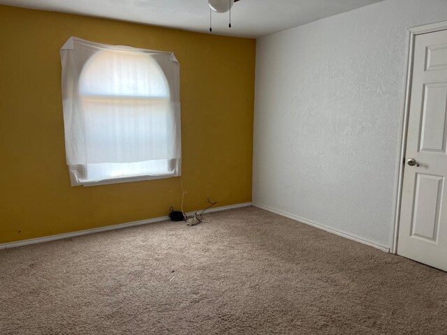 unfurnished room featuring ceiling fan, a healthy amount of sunlight, and carpet flooring