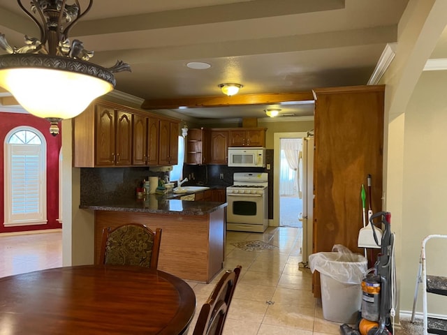 kitchen featuring white appliances, tasteful backsplash, ornamental molding, light tile patterned flooring, and kitchen peninsula