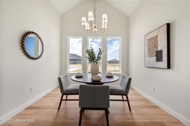 808 E 19th St, Wolfforth, TX 79382 - dining space featuring a chandelier, light wood finished floors, baseboards, and high vaulted ceiling