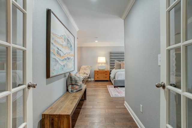 hallway with crown molding, french doors, and hardwood / wood-style flooring