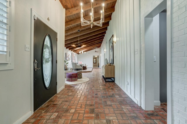 entrance foyer featuring a notable chandelier, beam ceiling, high vaulted ceiling, and wooden ceiling