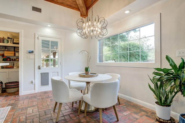 dining room with an inviting chandelier, plenty of natural light, lofted ceiling with beams, and built in features