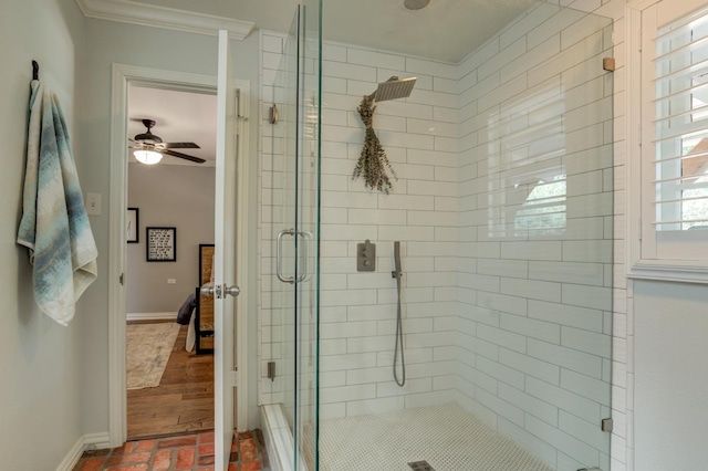 bathroom with an enclosed shower, ornamental molding, and ceiling fan