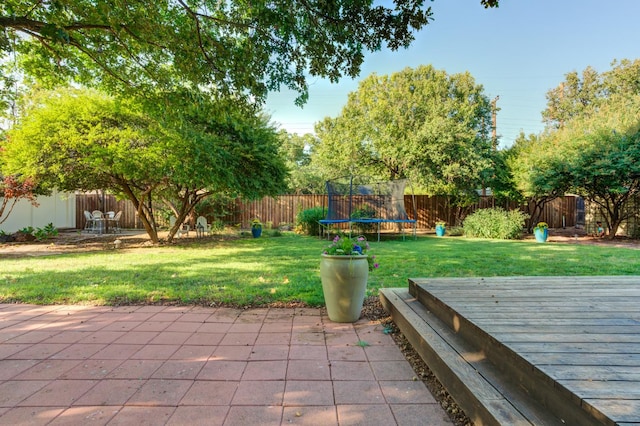 view of patio / terrace featuring a trampoline and a deck