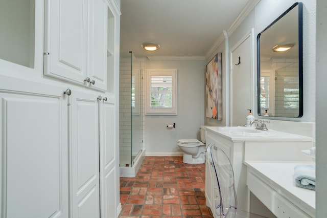 bathroom with a shower with door, crown molding, vanity, and toilet