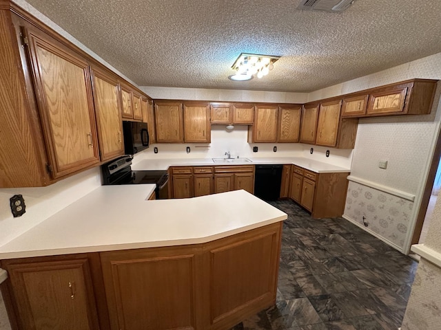 kitchen featuring sink, black appliances, kitchen peninsula, and a textured ceiling