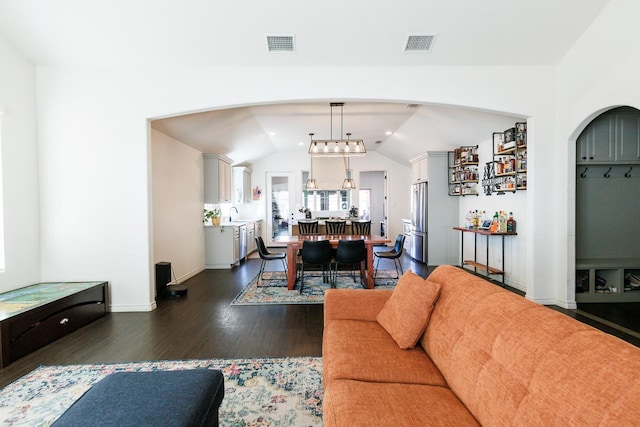 living room with lofted ceiling and dark hardwood / wood-style floors