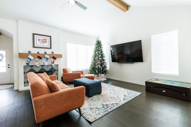 living room featuring lofted ceiling with beams, dark hardwood / wood-style floors, and a healthy amount of sunlight