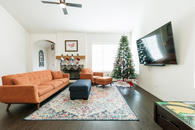 living room with dark hardwood / wood-style flooring and ceiling fan