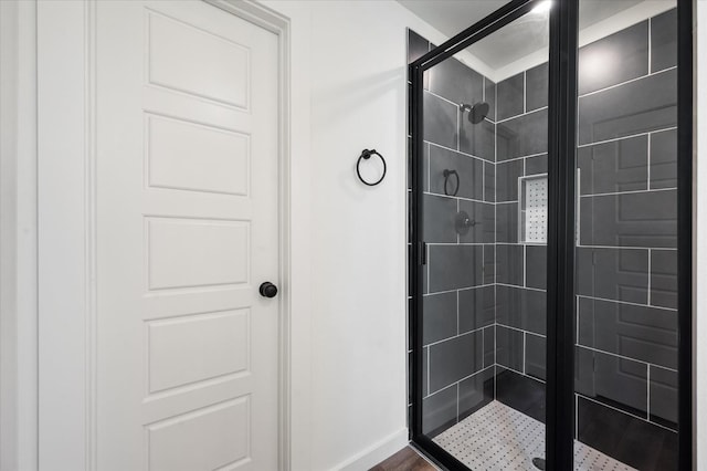 bathroom with a shower with shower door