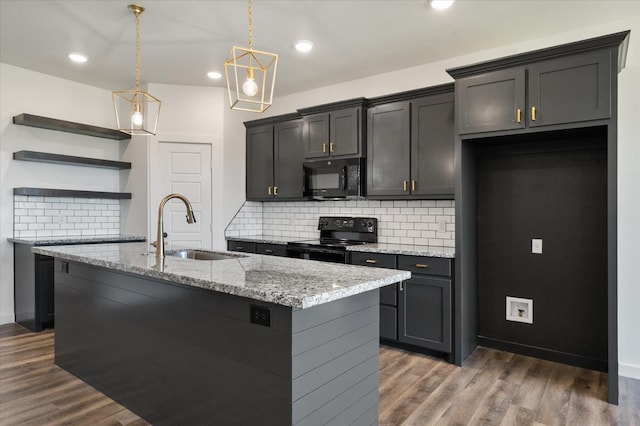 kitchen featuring decorative light fixtures, sink, dark hardwood / wood-style flooring, light stone counters, and black appliances