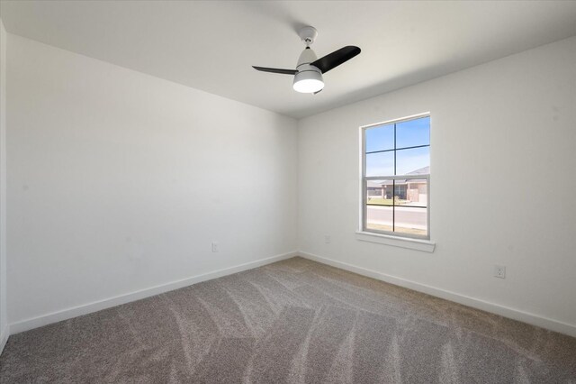 unfurnished room featuring ceiling fan and carpet