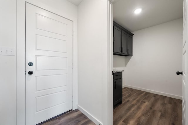 clothes washing area featuring dark wood-type flooring