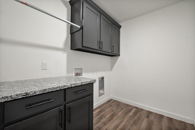 clothes washing area with cabinets, dark hardwood / wood-style floors, and hookup for a washing machine