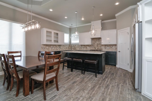 dining room with crown molding and dark hardwood / wood-style flooring