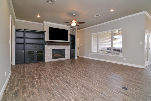 unfurnished living room featuring dark hardwood / wood-style flooring, crown molding, ceiling fan, and a fireplace