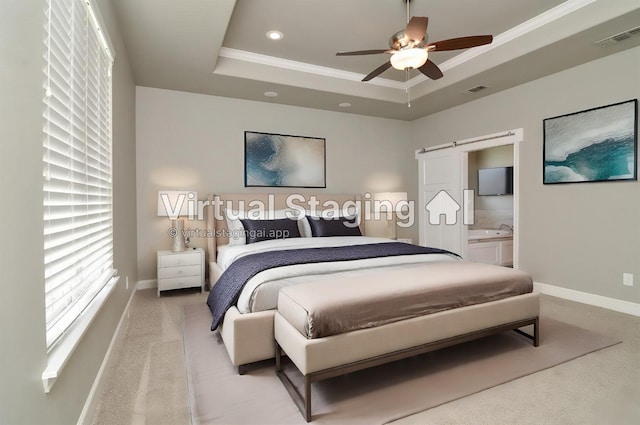 bedroom featuring a raised ceiling, crown molding, a barn door, and light carpet