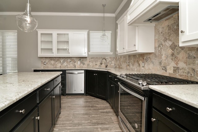 kitchen with crown molding, premium range hood, hanging light fixtures, stainless steel appliances, and white cabinets