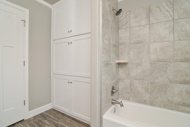 bathroom featuring tiled shower / bath and wood-type flooring