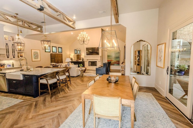 dining space featuring sink, a notable chandelier, a towering ceiling, beam ceiling, and light parquet floors