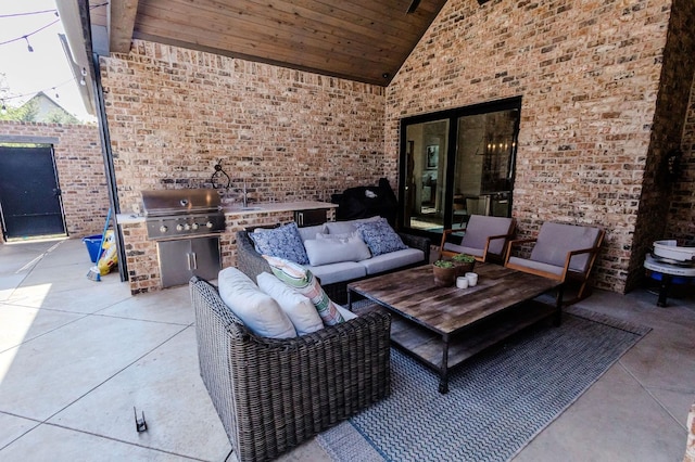 view of patio with exterior kitchen, a grill, sink, and an outdoor living space