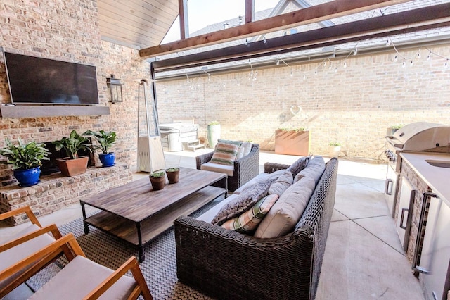 view of patio featuring grilling area, an outdoor living space, and exterior kitchen