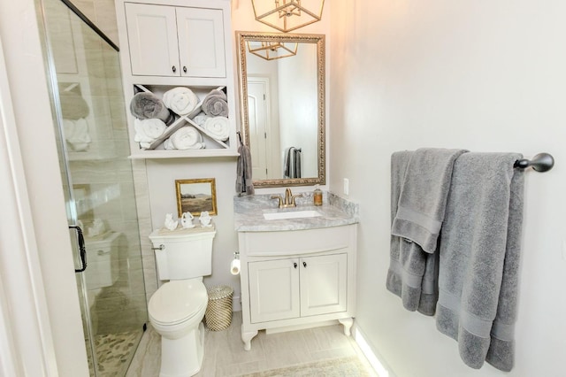 bathroom featuring vanity, toilet, and walk in shower