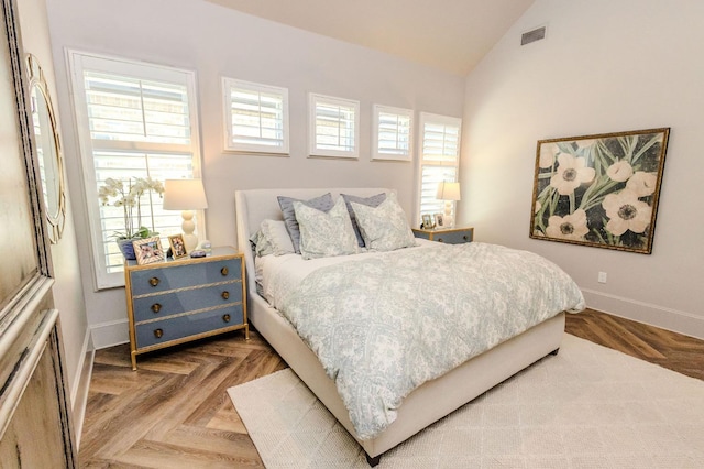 bedroom featuring parquet floors, vaulted ceiling, and multiple windows