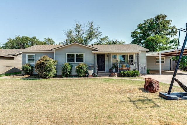 ranch-style home featuring a porch, a carport, and a front yard