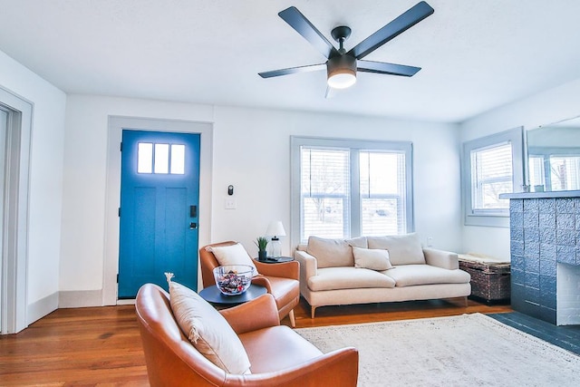 living room with ceiling fan and dark hardwood / wood-style floors