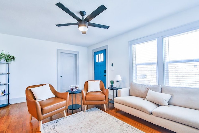 living room with hardwood / wood-style flooring and ceiling fan