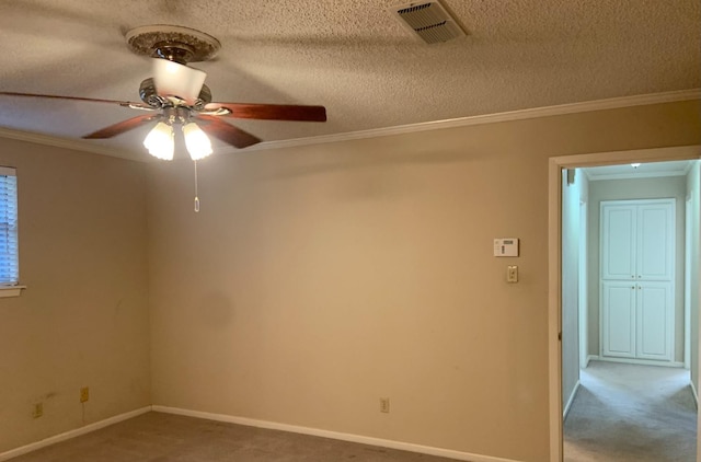 empty room with ornamental molding, carpet flooring, and a textured ceiling