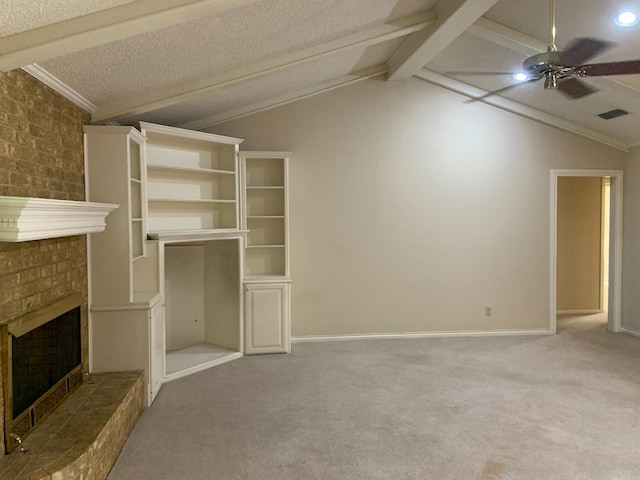 unfurnished living room with a fireplace, lofted ceiling with beams, carpet, ceiling fan, and a textured ceiling