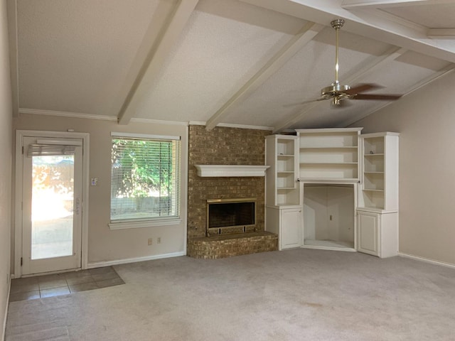 unfurnished living room featuring ceiling fan, light carpet, a brick fireplace, and vaulted ceiling with beams