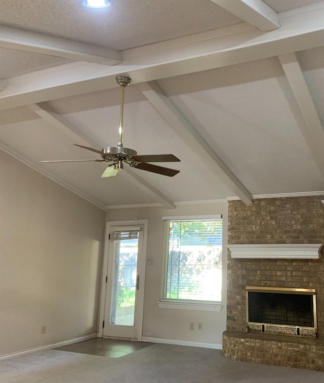 unfurnished living room featuring vaulted ceiling with beams, ornamental molding, a textured ceiling, and ceiling fan