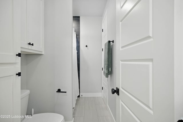 13803 Quinton Ave, Lubbock, TX 79424 - bathroom featuring toilet and a shower with curtain