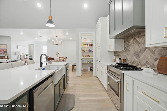 13803 Quinton Ave, Lubbock, TX 79424 - kitchen featuring stainless steel appliances, range hood, light countertops, white cabinetry, and recessed lighting