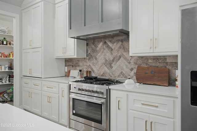 13803 Quinton Ave, Lubbock, TX 79424 - kitchen featuring stainless steel range with gas cooktop, light countertops, tasteful backsplash, and white cabinets