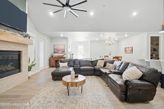 13803 Quinton Ave, Lubbock, TX 79424 - living area with a fireplace, light wood-type flooring, a chandelier, ceiling fan, and recessed lighting