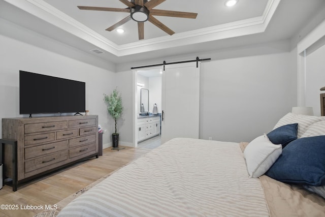 13803 Quinton Ave, Lubbock, TX 79424 - bedroom with a barn door, a raised ceiling, light wood-type flooring, ornamental molding, and recessed lighting