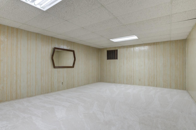 spare room featuring a paneled ceiling and carpet