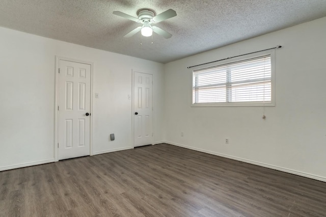 unfurnished bedroom featuring ceiling fan, dark hardwood / wood-style floors, and a textured ceiling