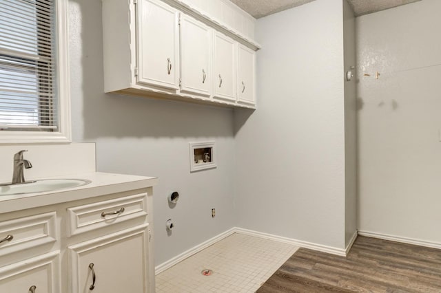 washroom with gas dryer hookup, dark hardwood / wood-style floors, sink, cabinets, and hookup for a washing machine