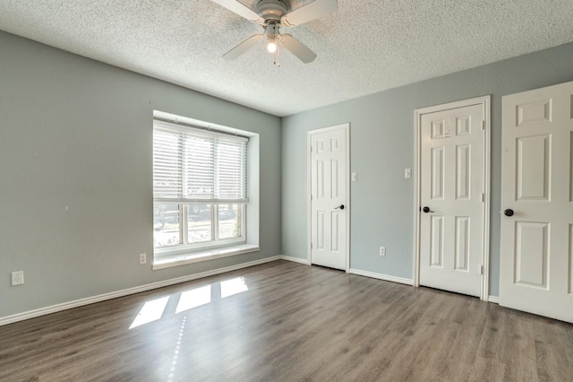 unfurnished bedroom featuring ceiling fan, hardwood / wood-style floors, and a textured ceiling