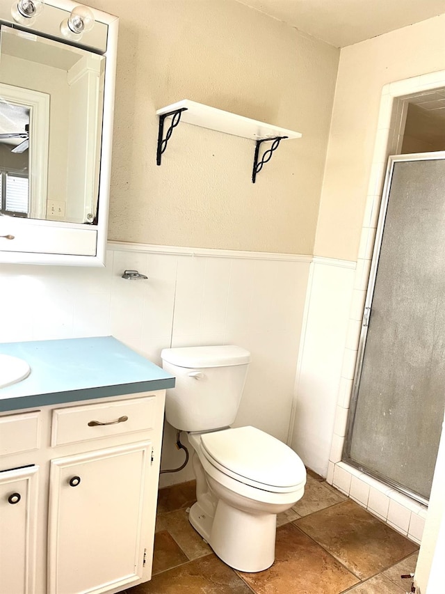 bathroom featuring walk in shower, vanity, and toilet