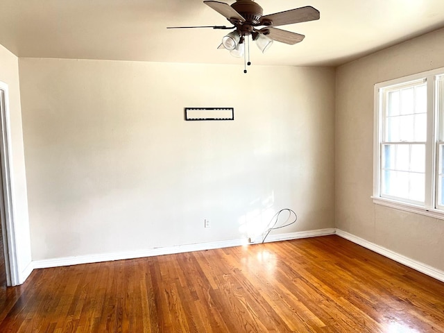 unfurnished room featuring hardwood / wood-style floors and ceiling fan