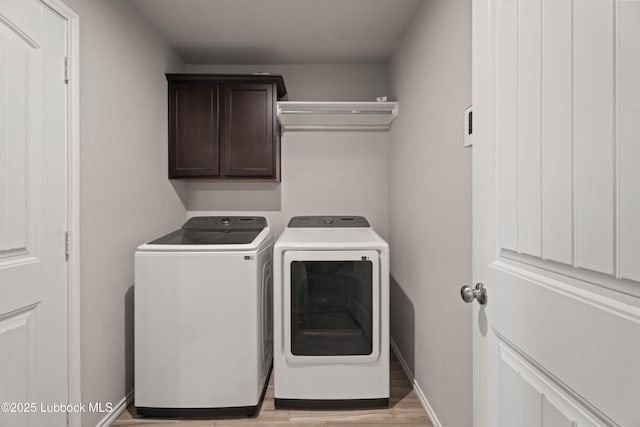 6827 38th St, Lubbock, TX 79407 - washroom with washing machine and dryer, cabinet space, light wood-type flooring, and baseboards
