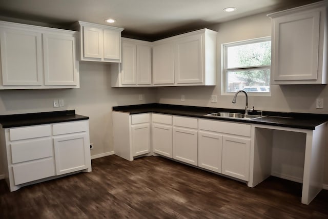 kitchen with dark hardwood / wood-style floors, sink, and white cabinets