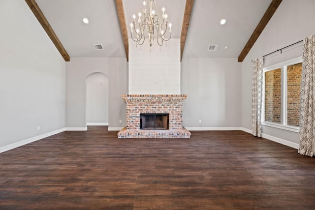 unfurnished living room featuring vaulted ceiling with beams, dark wood-type flooring, and a fireplace